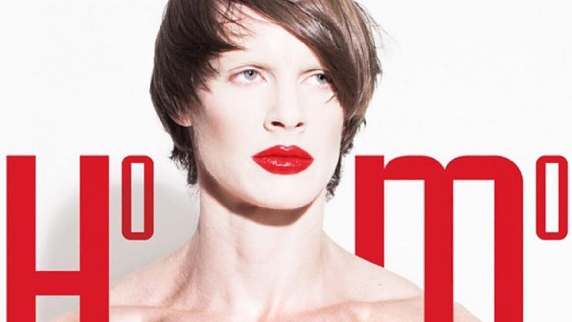 Artistic photo of Cassils with makeup and muscular chest, part of censored yet reinstalled LGBTQ+ art in Berlin.