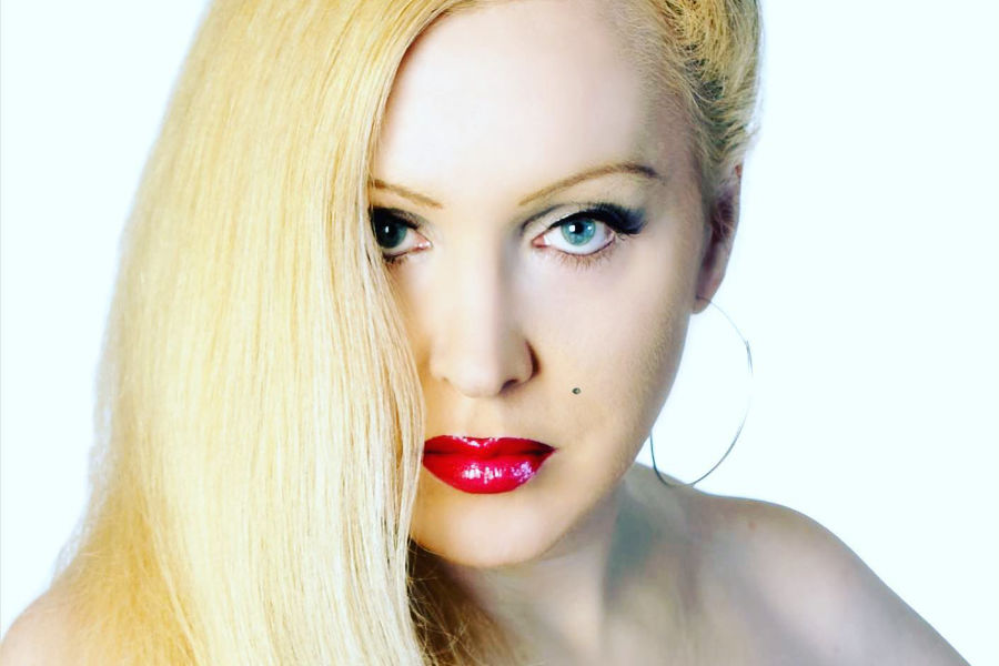 Portrait of Estelle Asmodelle with long blonde hair and red lipstick, taken for her NY Glamour magazine interview.