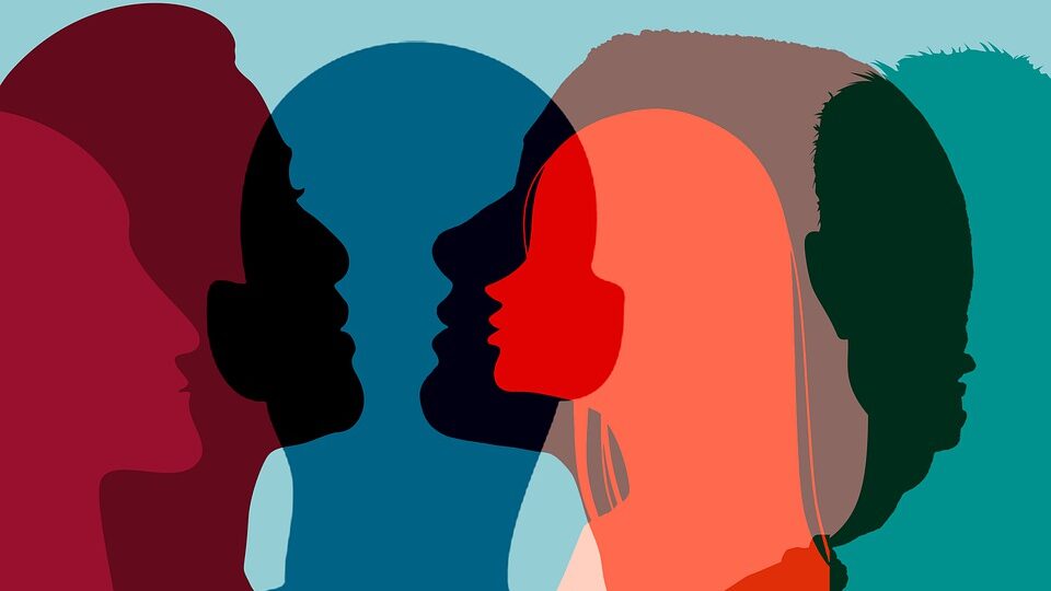 Una ilustración moderna con perfiles de personas superpuestos y coloridos, que enfatiza la unidad y la diversidad en un estilo minimalista.