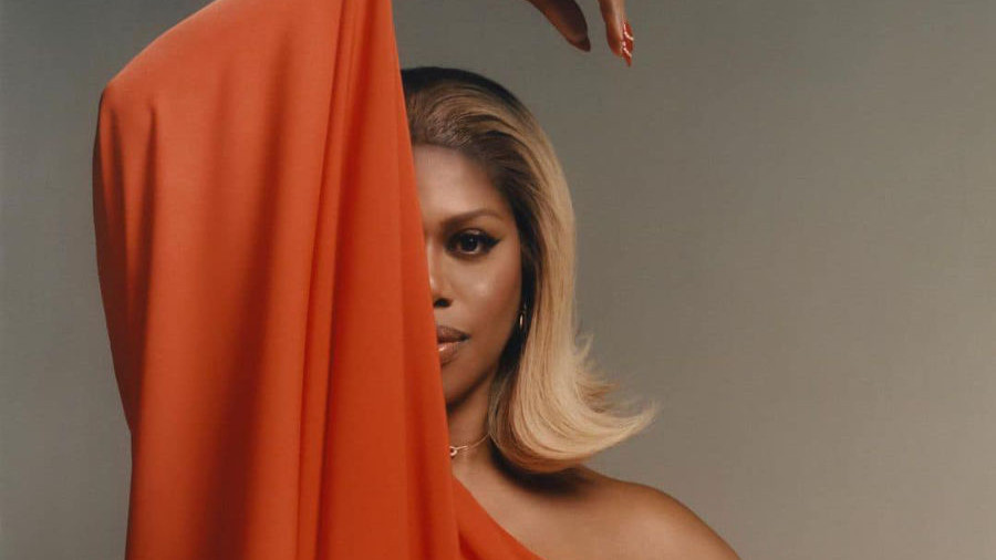 Laverne Cox poses in an orange dress, one arm hidden, for Inventing Anna promo in 2022.