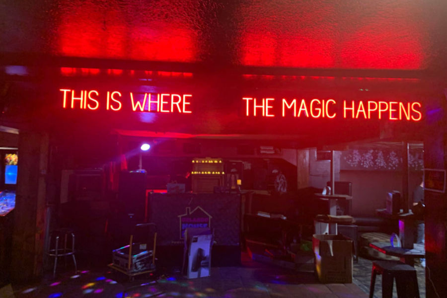 Neon sign at St. Matthew’s Tavern in Orlando reading “This is where the magic happens” above the bar area.