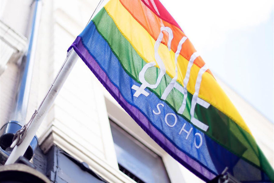 Rainbow flag with “She Soho” flying outside a building during a Pride party in London.