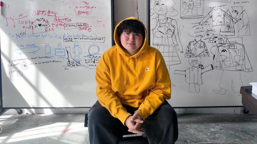 Victor Langlois seated in front of two whiteboards covered in sketches and notes.